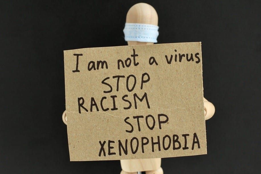 cardboard-sign-with-text-in-the-hands-of-a-wooden-doll-or-mannequin-in-a-medical-mask-concept-of-anti_t20_mLr6E3.jpg