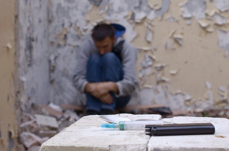 a-drug-dependent-man-suffers-from-drug-withdrawal-while-sitting-in-abandoned-building-and-items-for_t20_lL8AVk.jpg