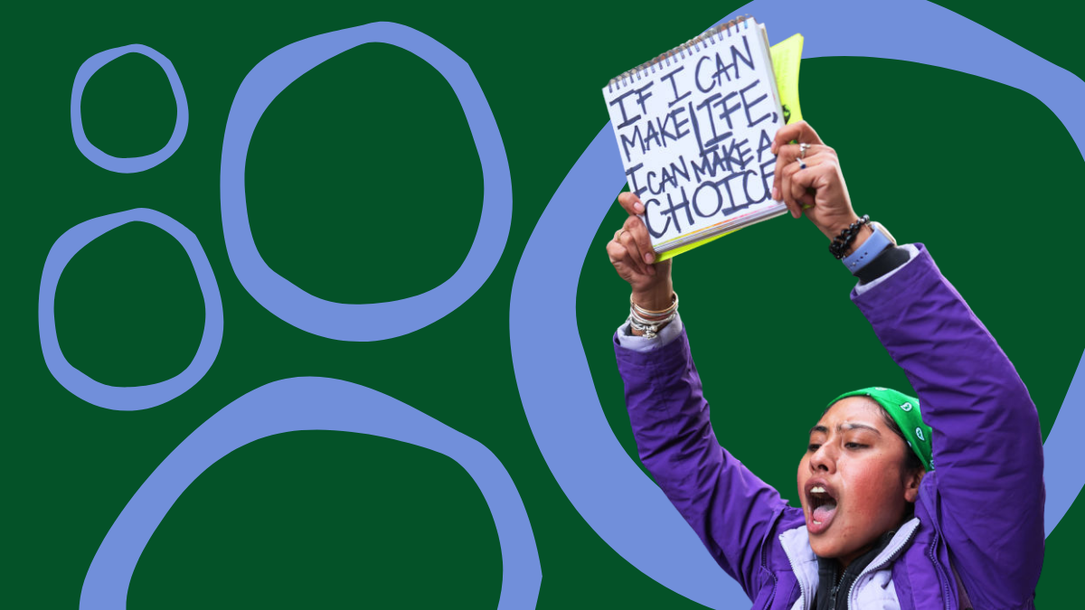 a woman wearing a purple jacket and green head bandana holds a sign reading "If I can make a life, I can make a choice"