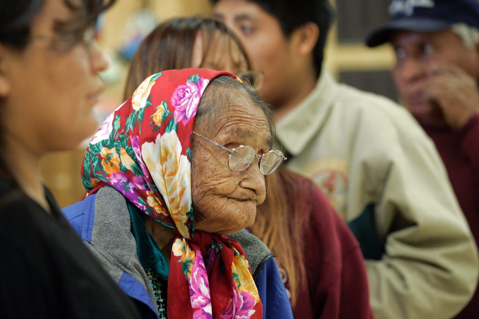 Side profile of Elsie Werito, 84, a member of the To'hajiilee Chapter of the Navajo Nation, waits in line to cast her ballot