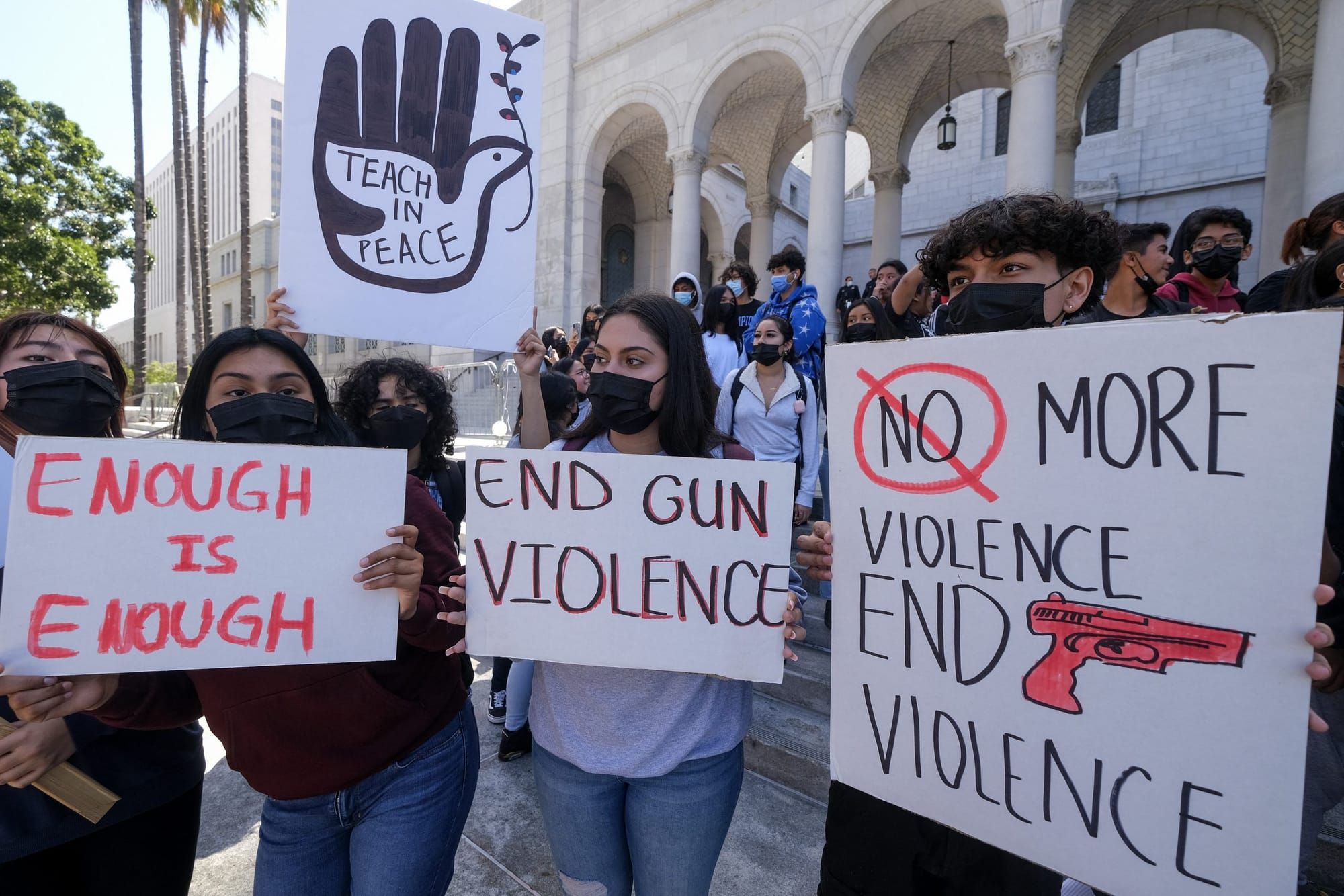 students hold signs protesting gun violence