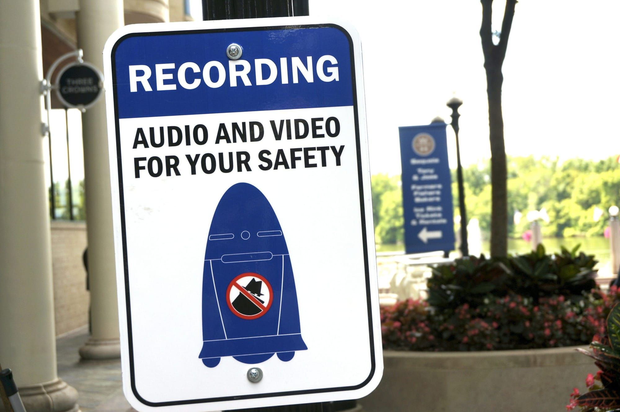a white sign with a blue rectangle on top and white text reading "Recording." below, in black text, it reads, "audio and vide