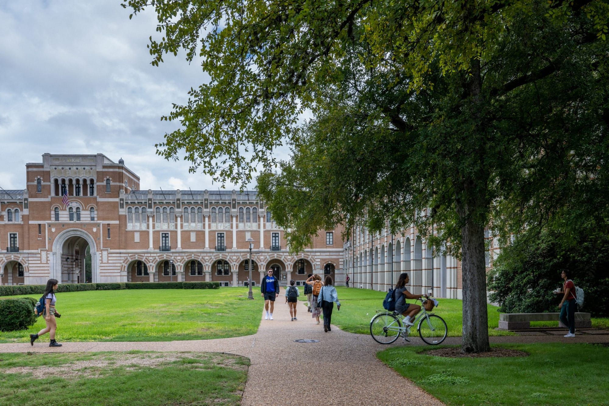 students walk across a college quad