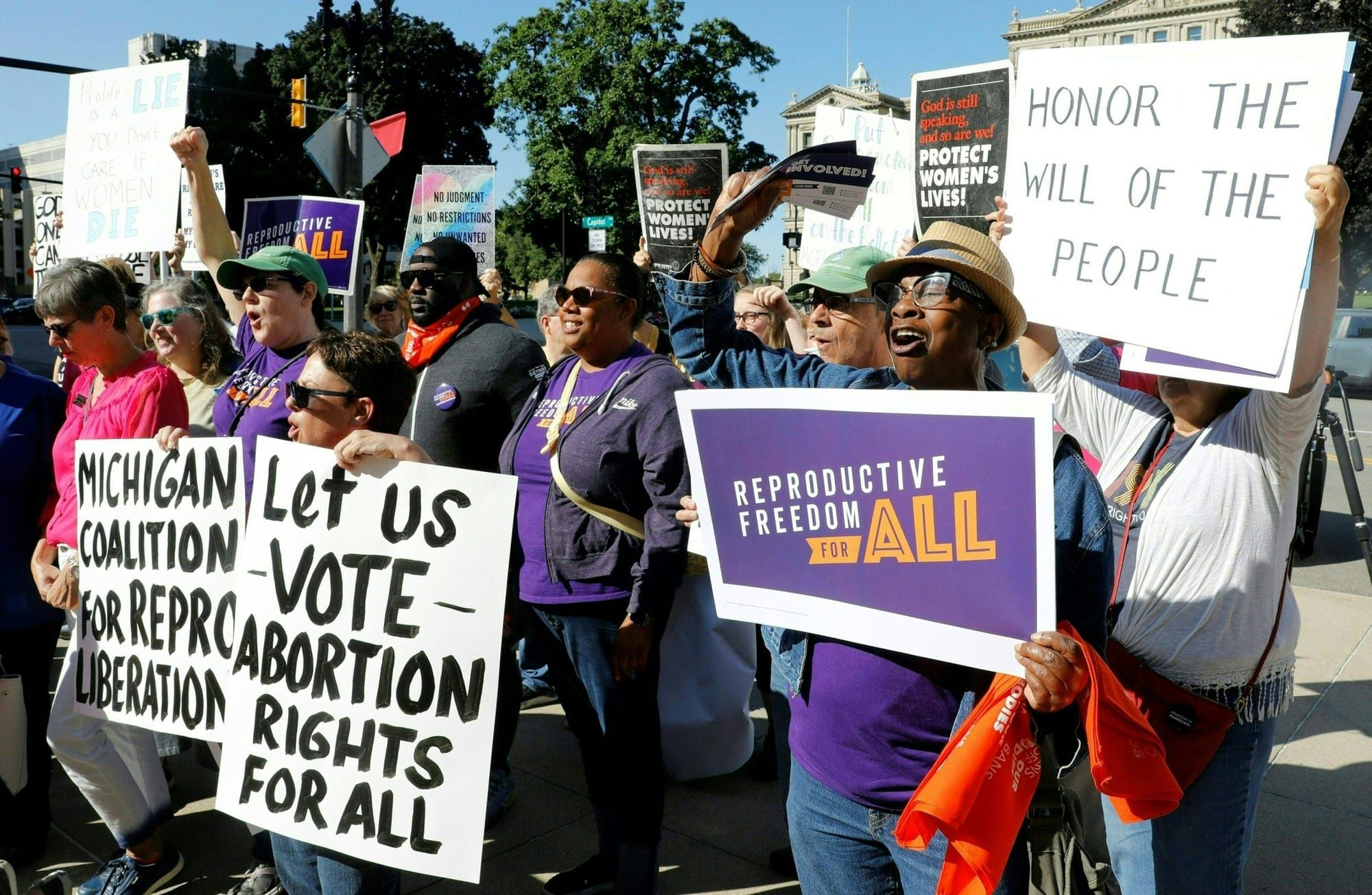 color photograph of pro-choice protesters holding paper signs with pro-choice messages such as "reproductive freedom for all"