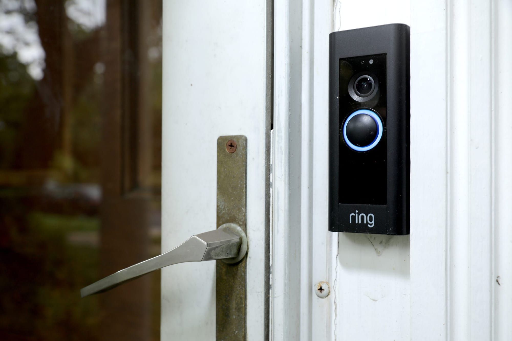 color photograph of a ring security camera doorbell on the right side of a house's door