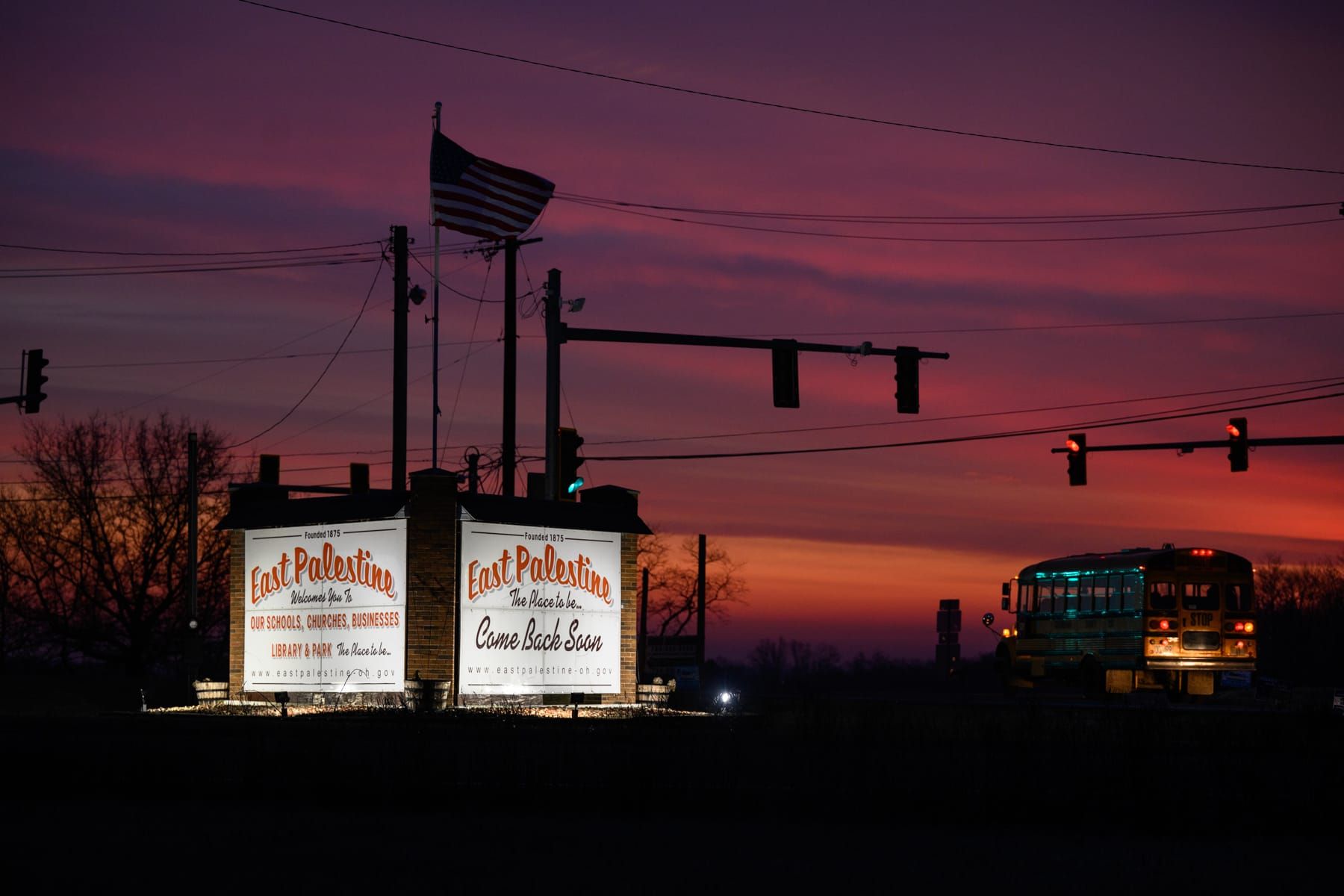 color outdoor photograph of a dark sunset sky. hues of purple, dark pink, and orange blend in the background. the silhouettes