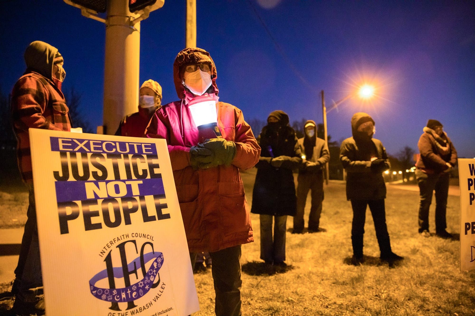 color photograph of an outdoor protest at night against the death penalty