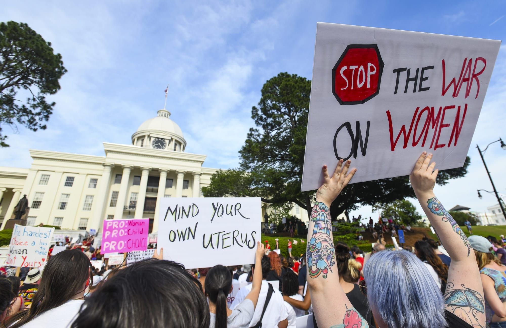 outdoor protest in front of a government building in support of women's bodily autonomy