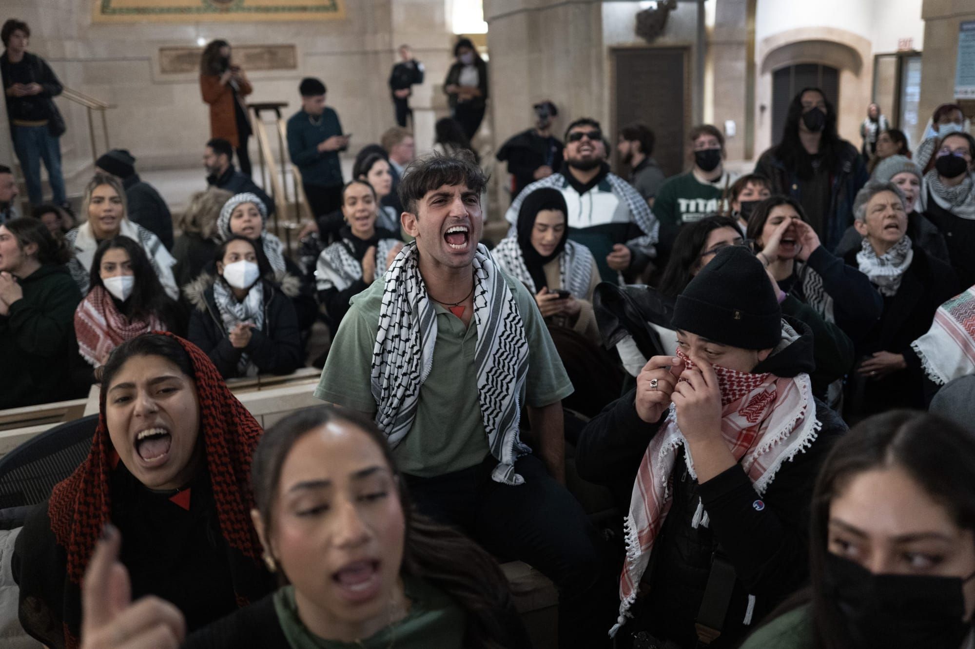 photograph of protest in Chicago city hall demanding ceasefire