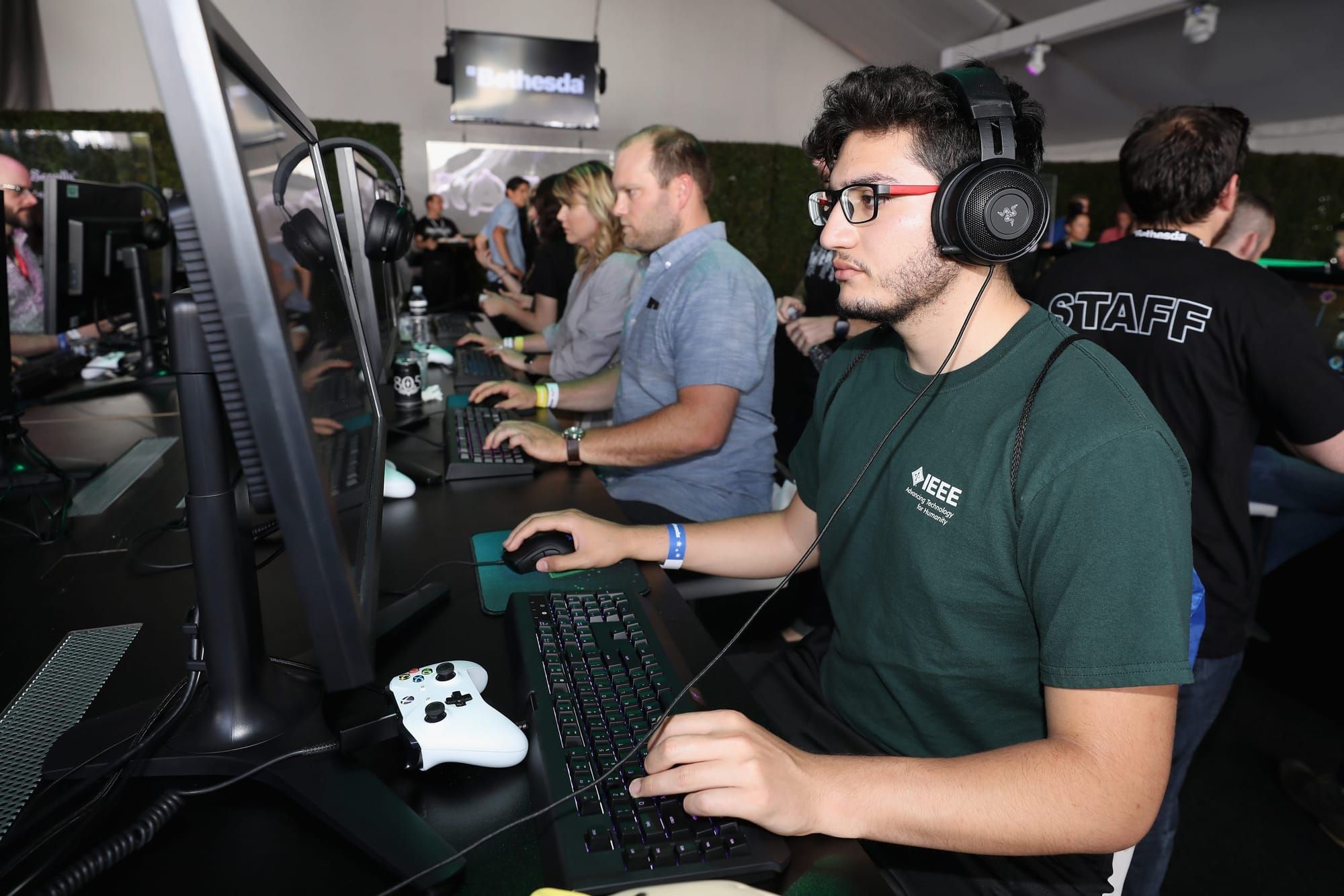 color photograph of video games workers sitting at a row of computers