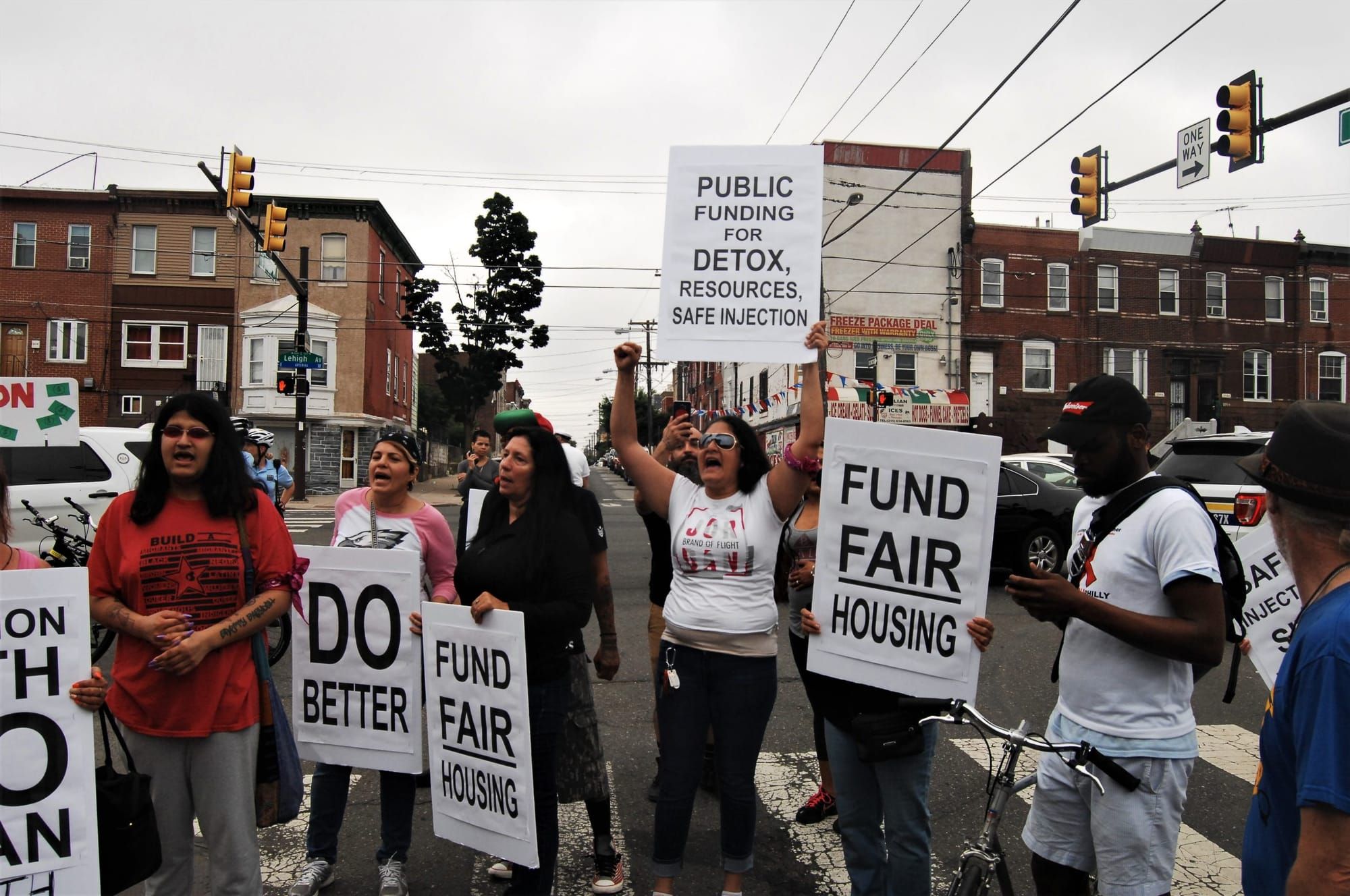 color photograph of an outdoor protest for funding housing and safe injection sites