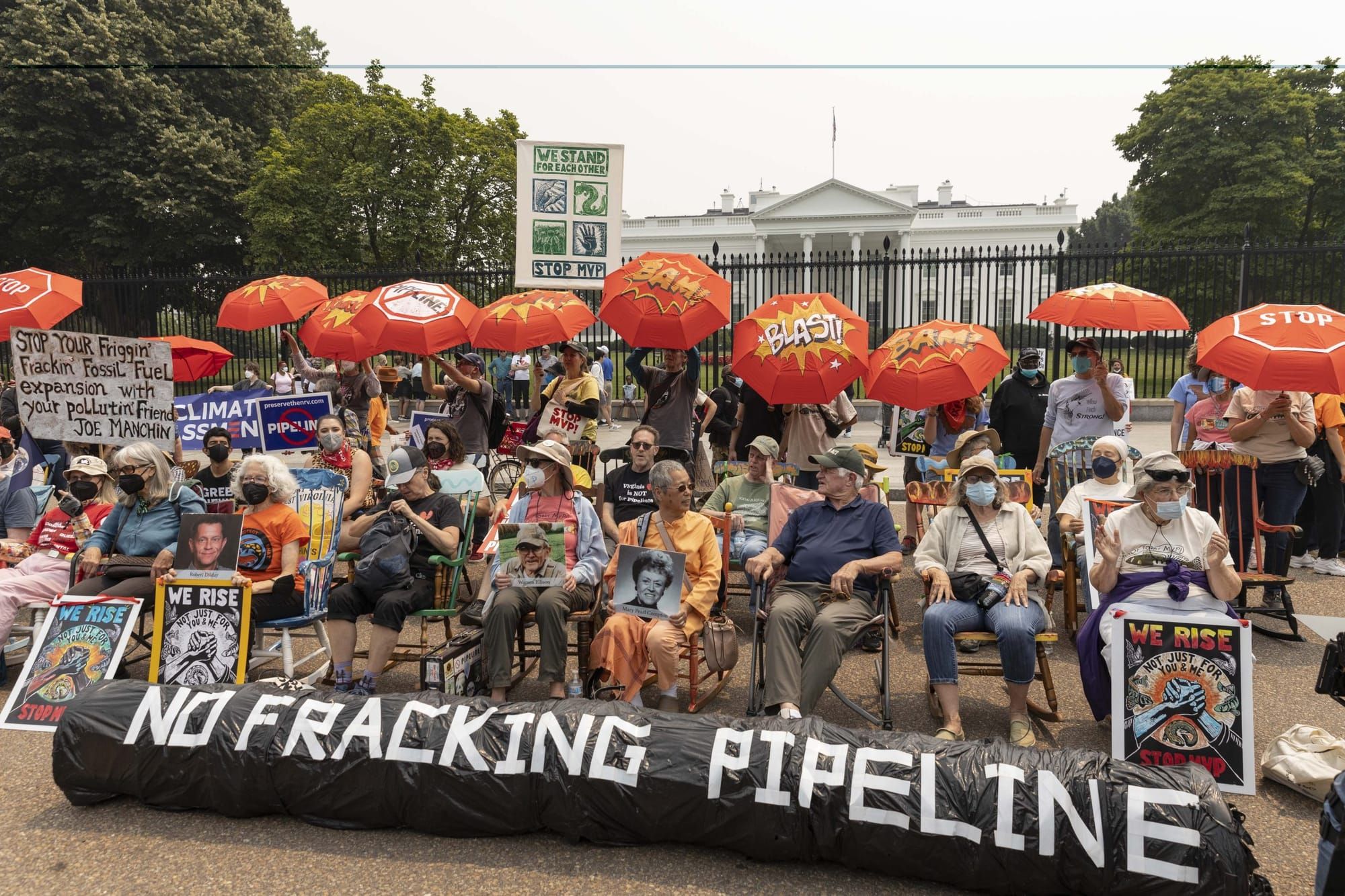 color photograph of an outdoor protest in front of the White House against fracking pipelines