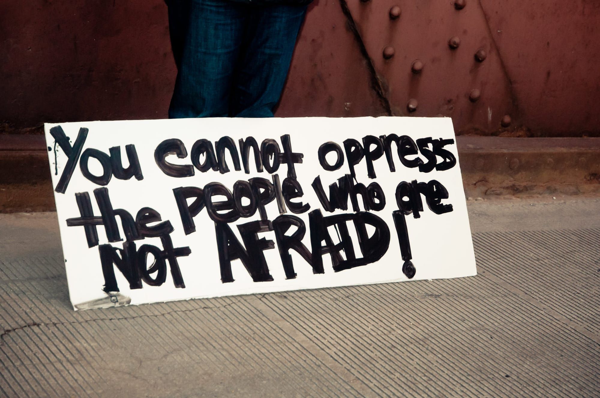 Protest sign reads, "You cannot oppress the people who are not afraid!" / Self-organize now or self-organize later