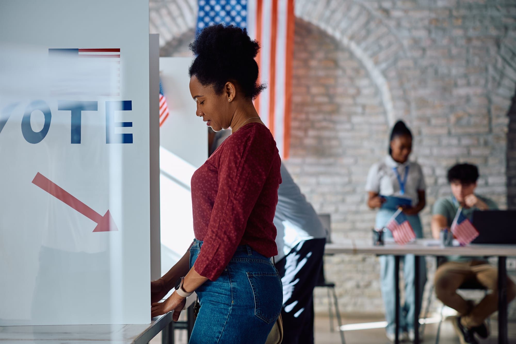 Woman stands in voting booth