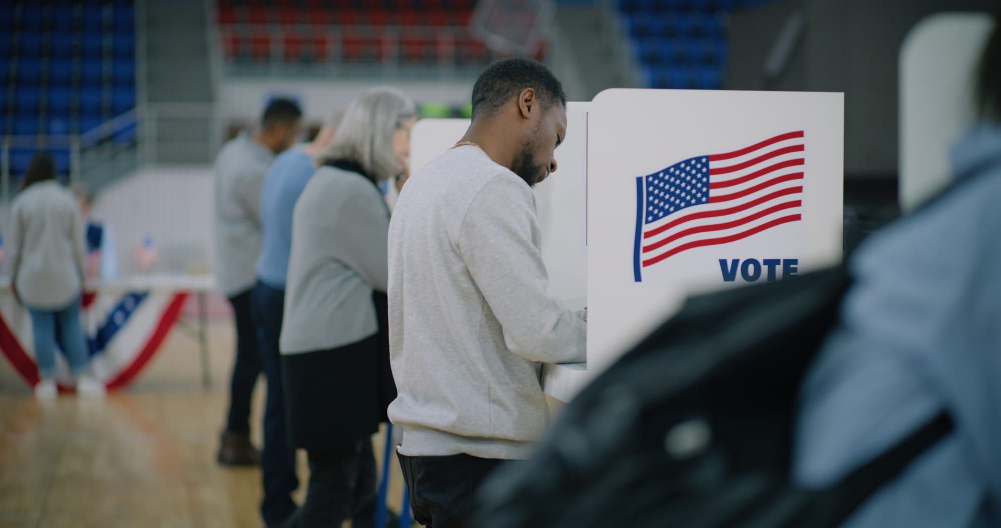 Male voter stands at voting booth