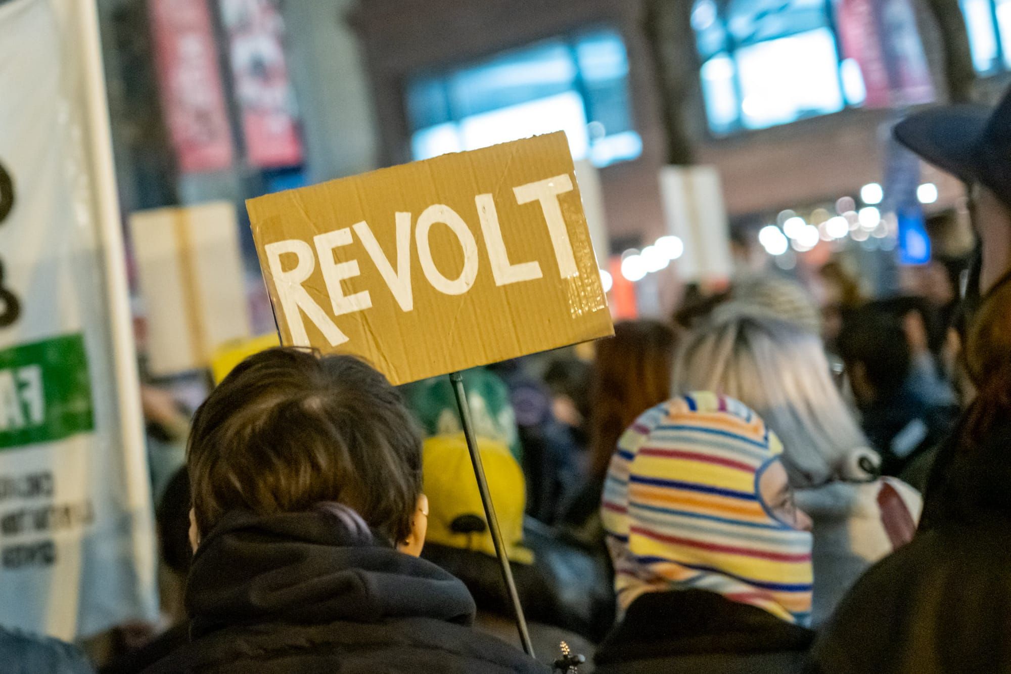 sign at protest that reads "Revolt"
