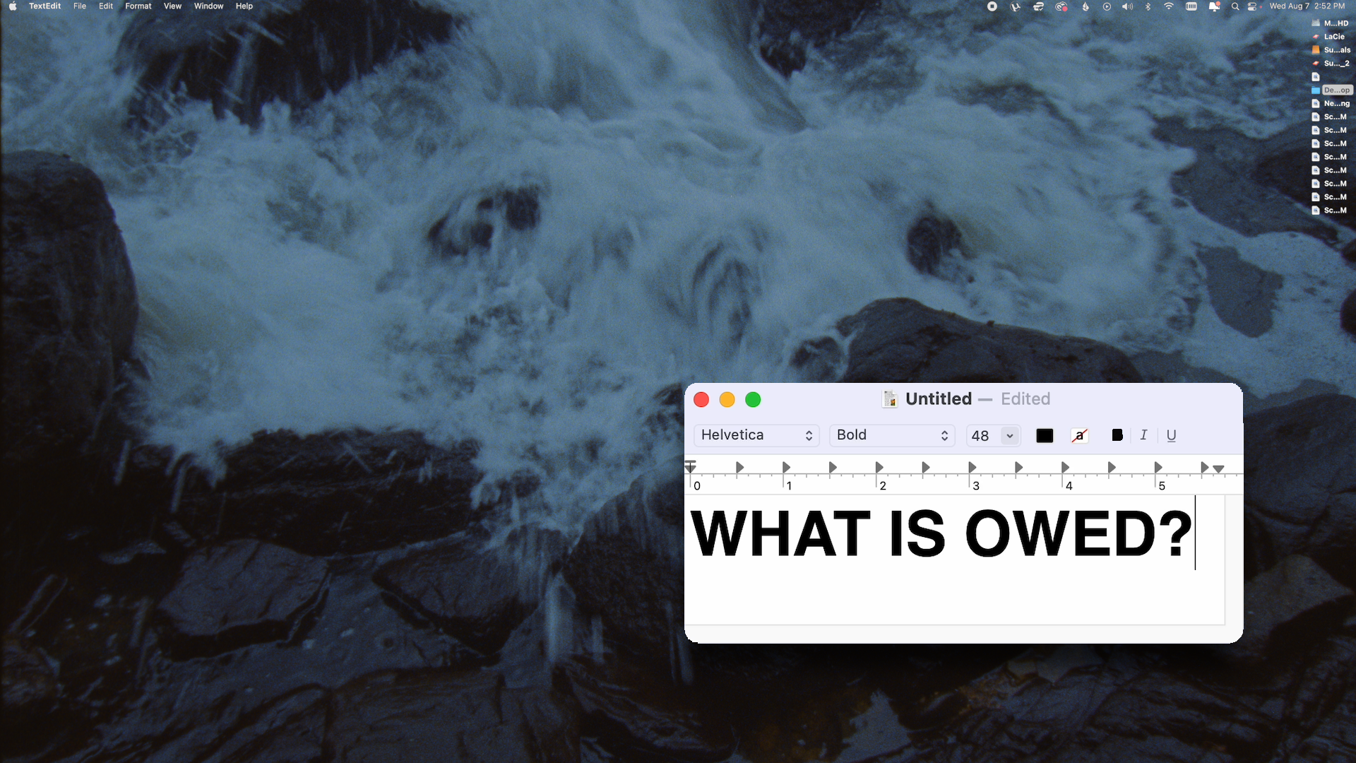“What is Owed” typed on a word processor appears in the bottom corner, with waves crashing against rocks in the background
