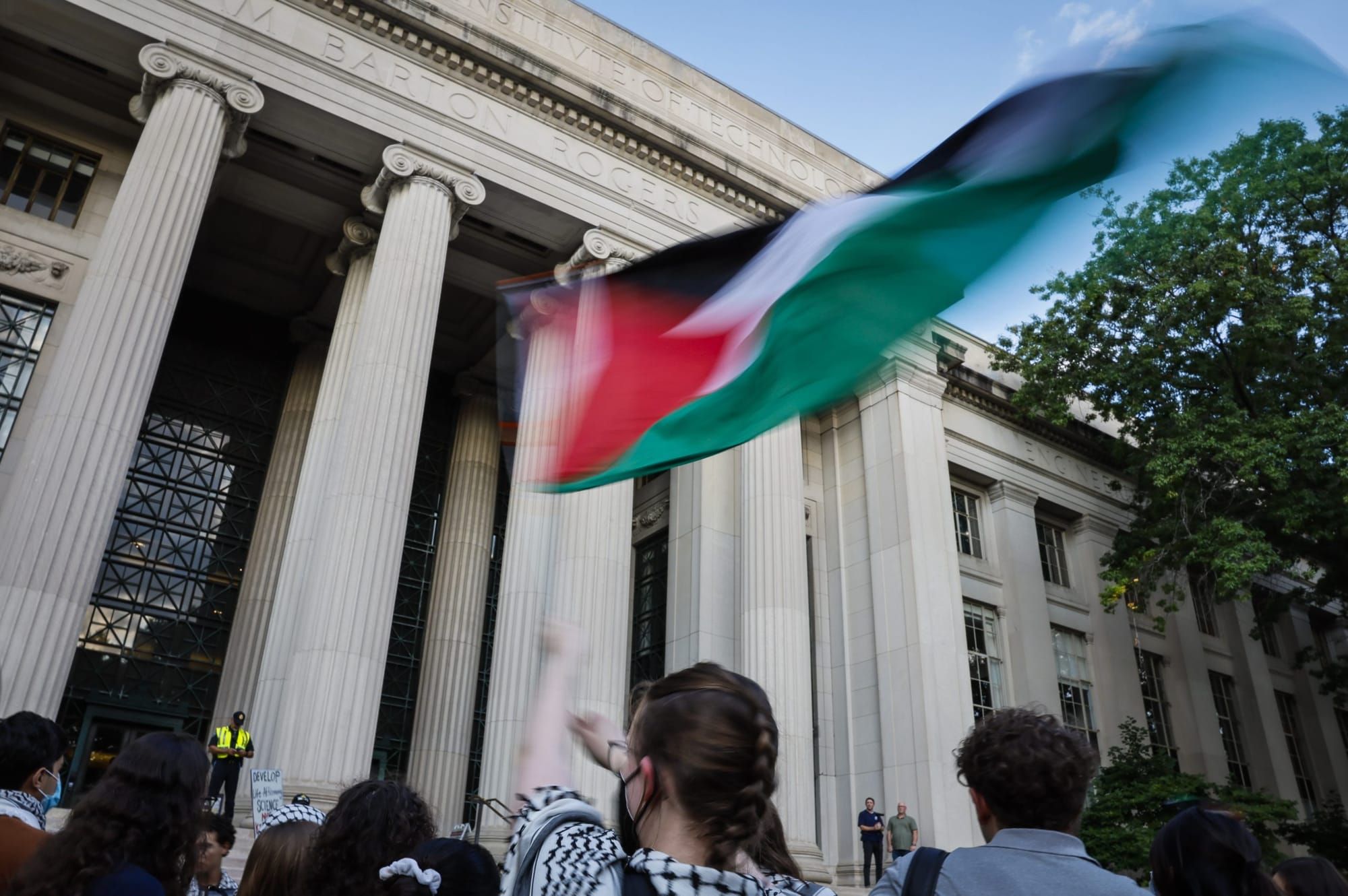 Palestinian flag waved by students outside MIT building