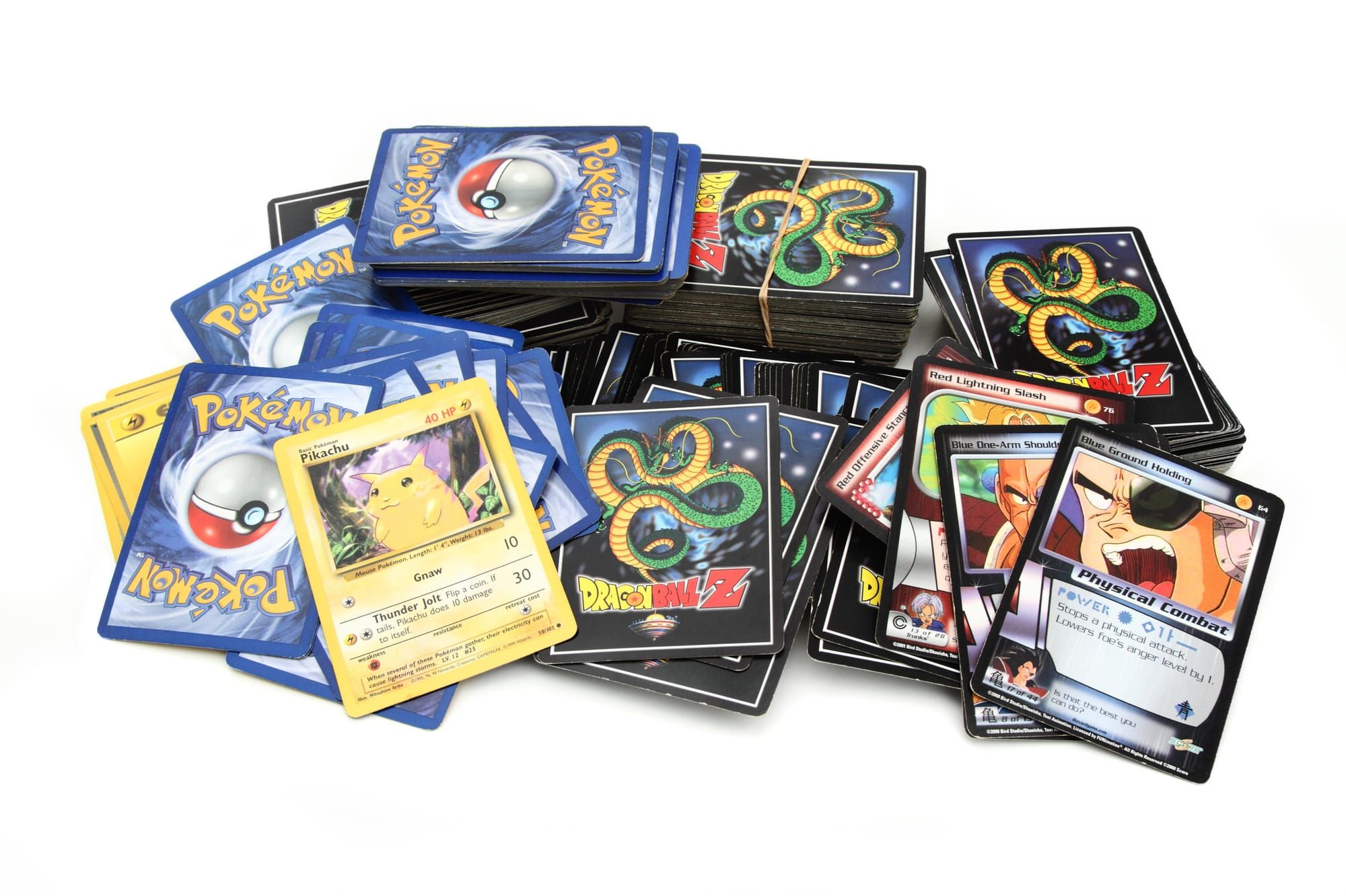 Stacks of Dragon Ball Z and Pokémon trading cards are displayed on a white background