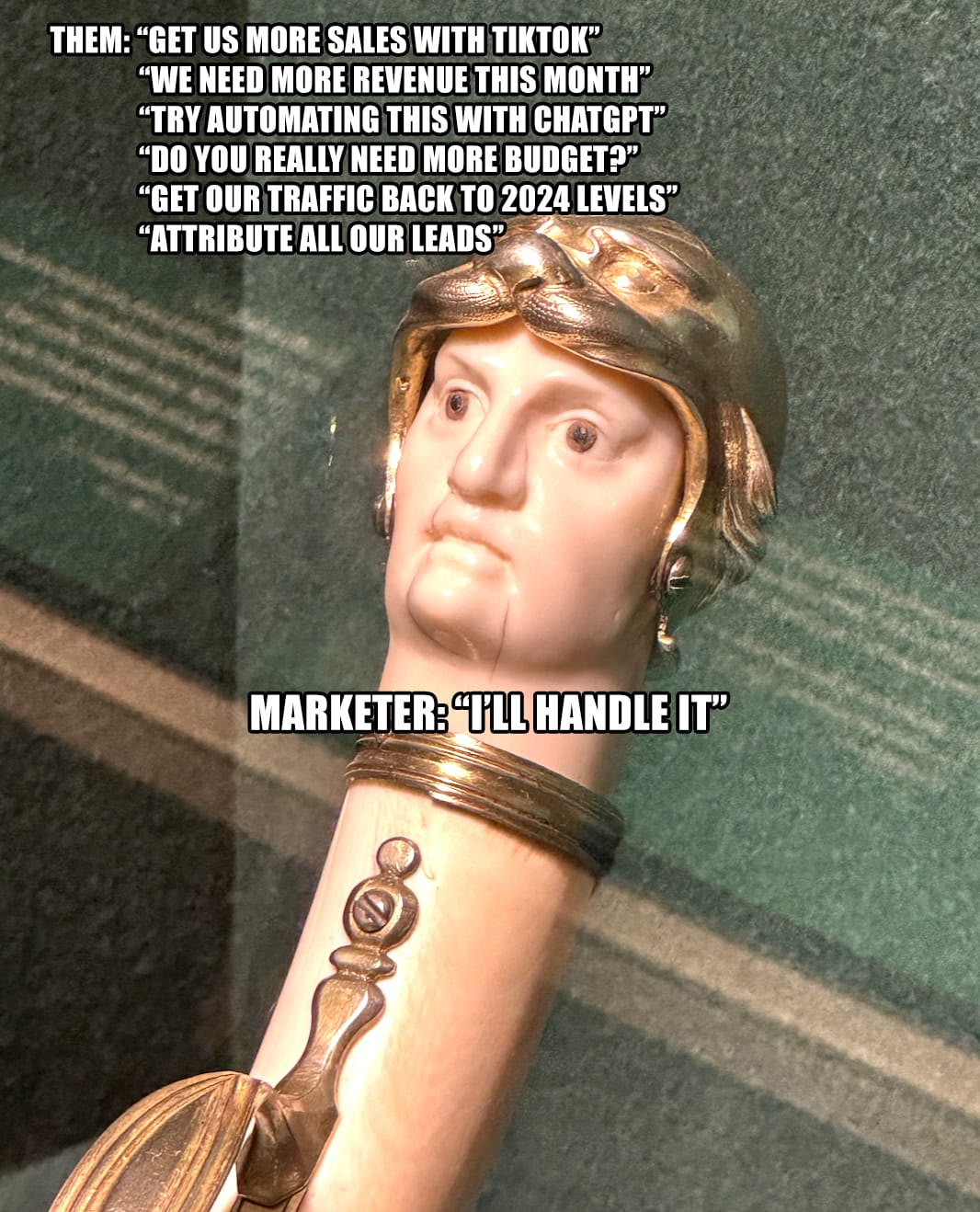 Photo of a silly looking gun handle in the shape of a face. A bunch of unreasonable marketing requests and answer is "I'll handle it"