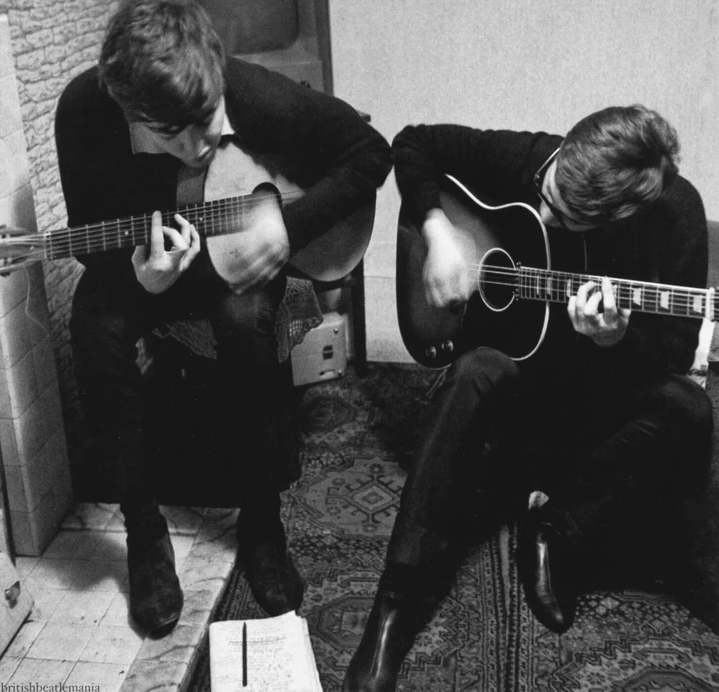 Photo of Paul McCartney and John Lennon writing “I Saw Her Standing There.”