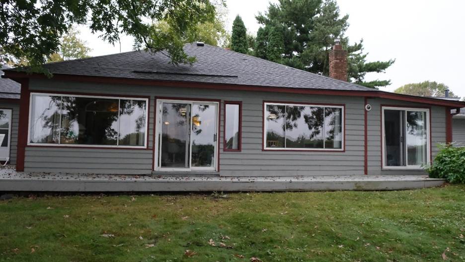 A grey house with a few windows

AI-generated content may be incorrect.