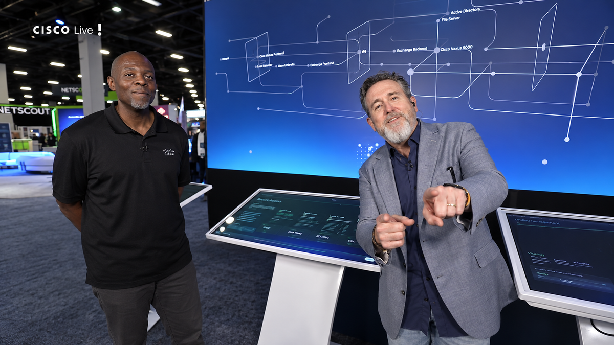 Robb Boyd speaks beside Splunk’s Jerald Perry in front of an interactive architecture display at Cisco Live US 2026.