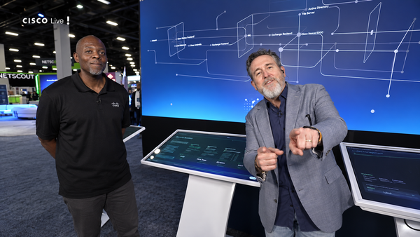 Robb Boyd speaks beside Splunk’s Jerald Perry in front of an interactive architecture display at Cisco Live US 2026.