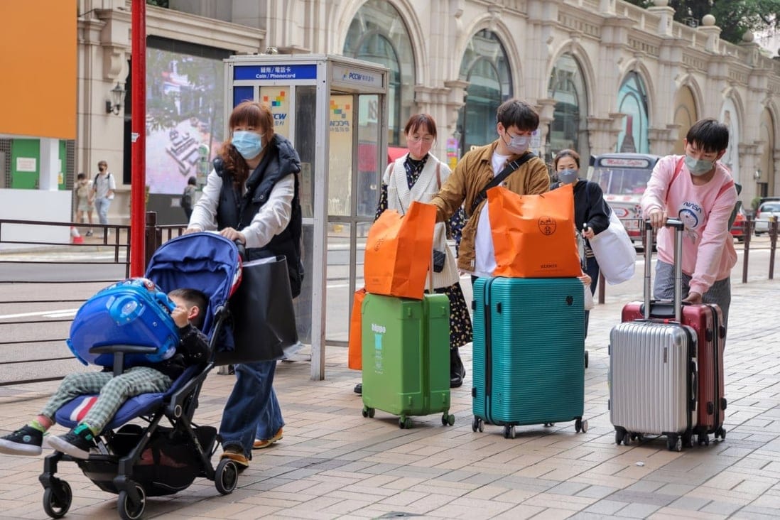 Tourists walk along Canton Road in Tsim Sha Tsui on the first day of a full reopening of the border between Hong Kong and mainland China on Monday. 
Photo: Jelly Tse
