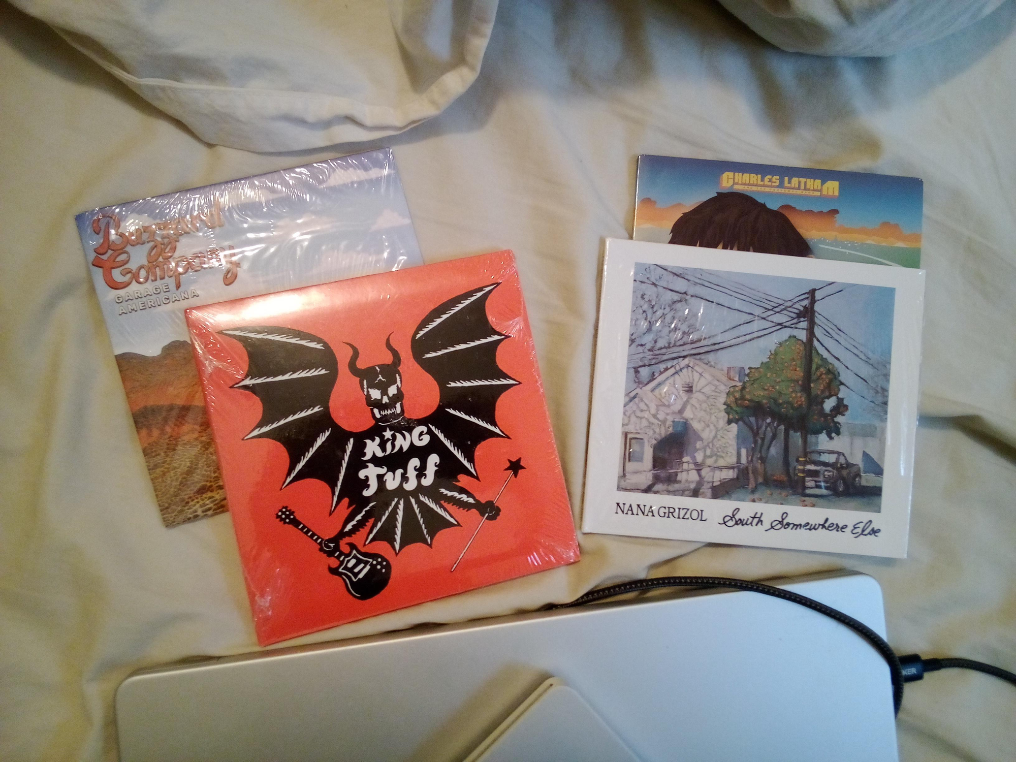 Four CDs, still in plastic wrap.