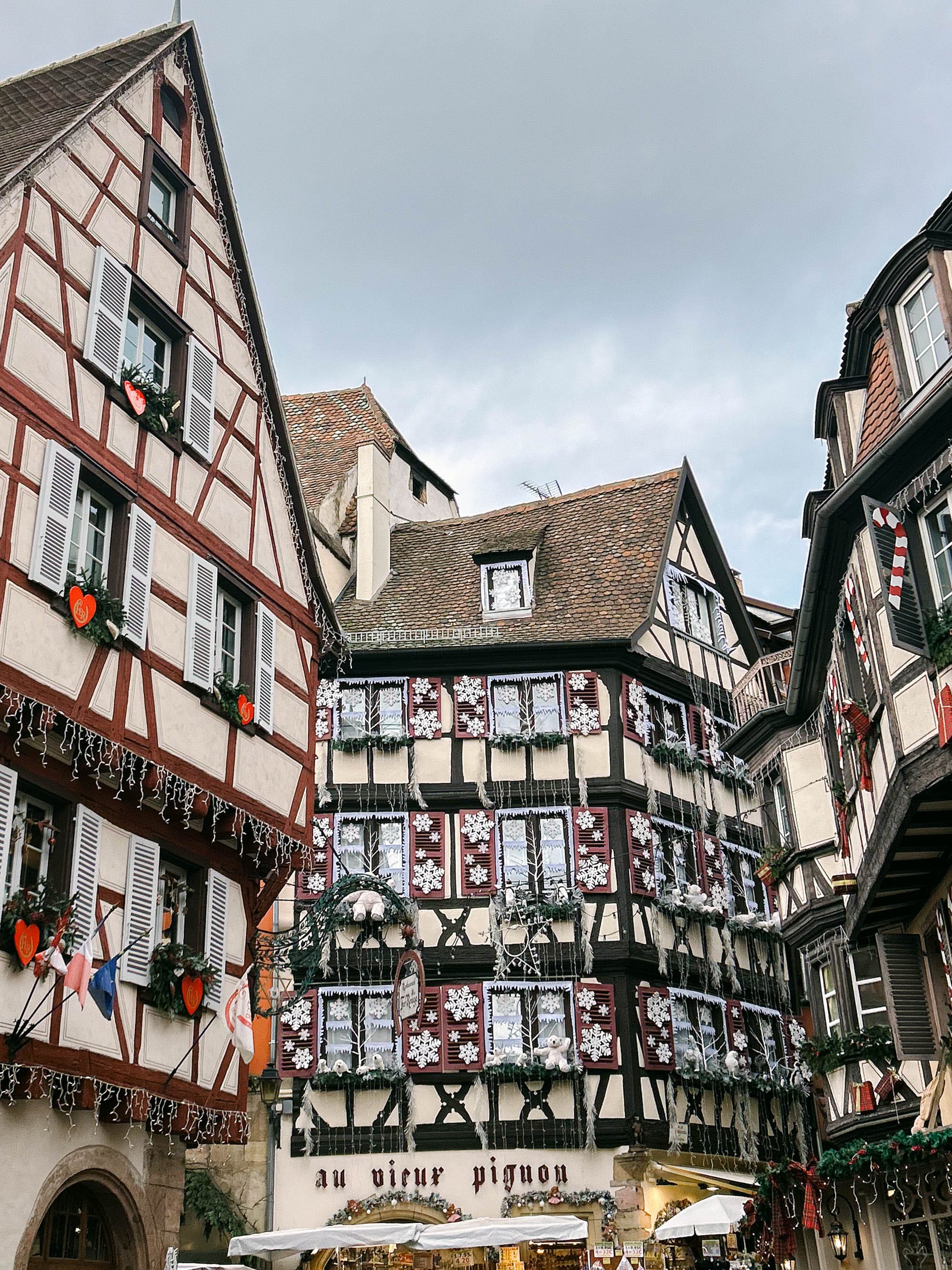 Half-timbered buildings in Colmar, France, including Au vieux pignon, decorated for the city's annual christmas markets.