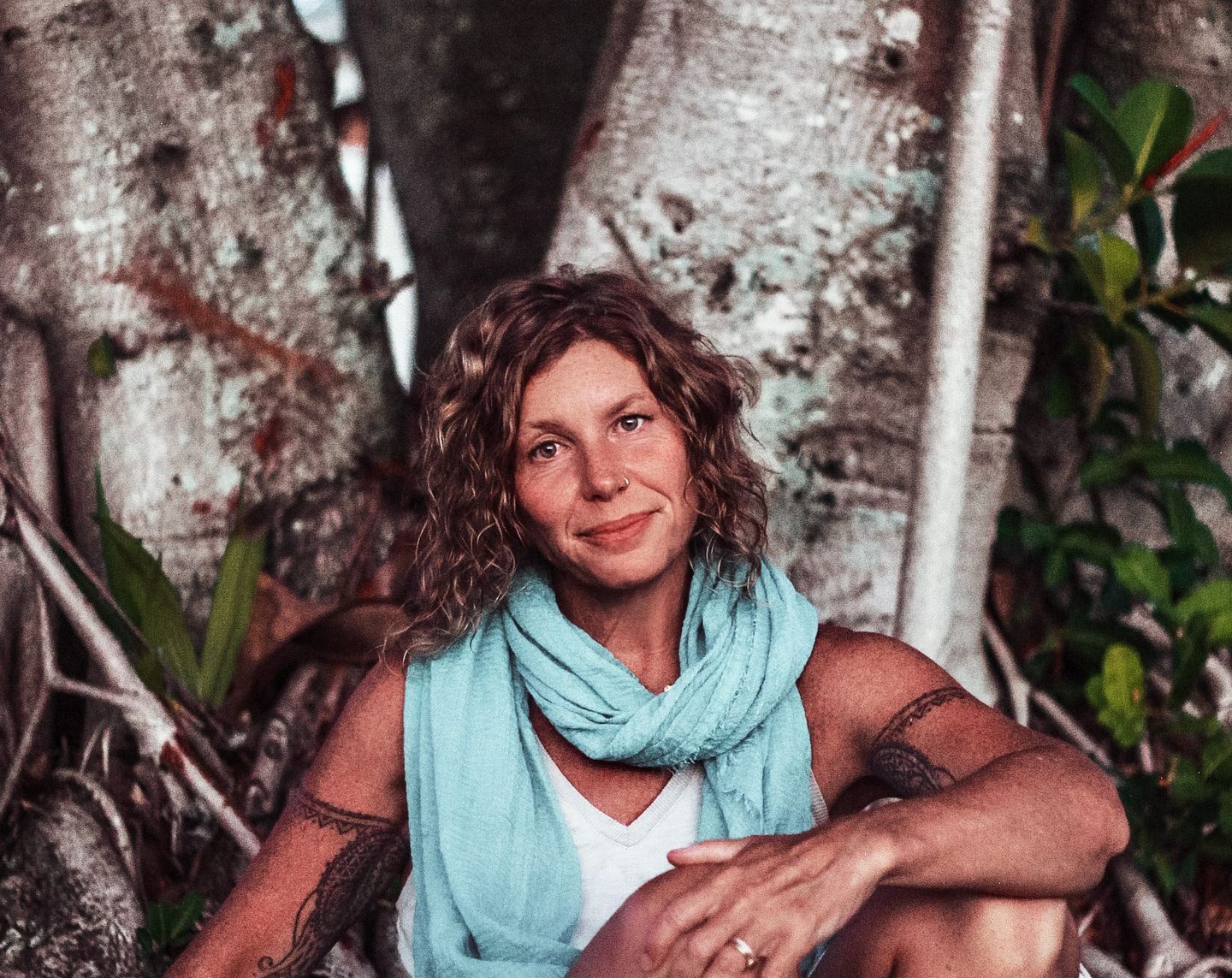 Portrait of Isha, a conscious parenting coach, smiling gently outdoors. She exudes warmth, wisdom, and calm energy, reflecting her holistic and compassionate approach.