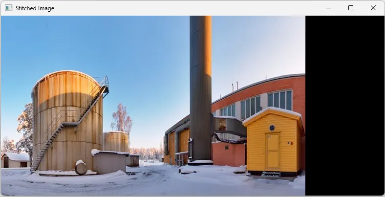 A building with a tall tower in the snow
Description automatically generated