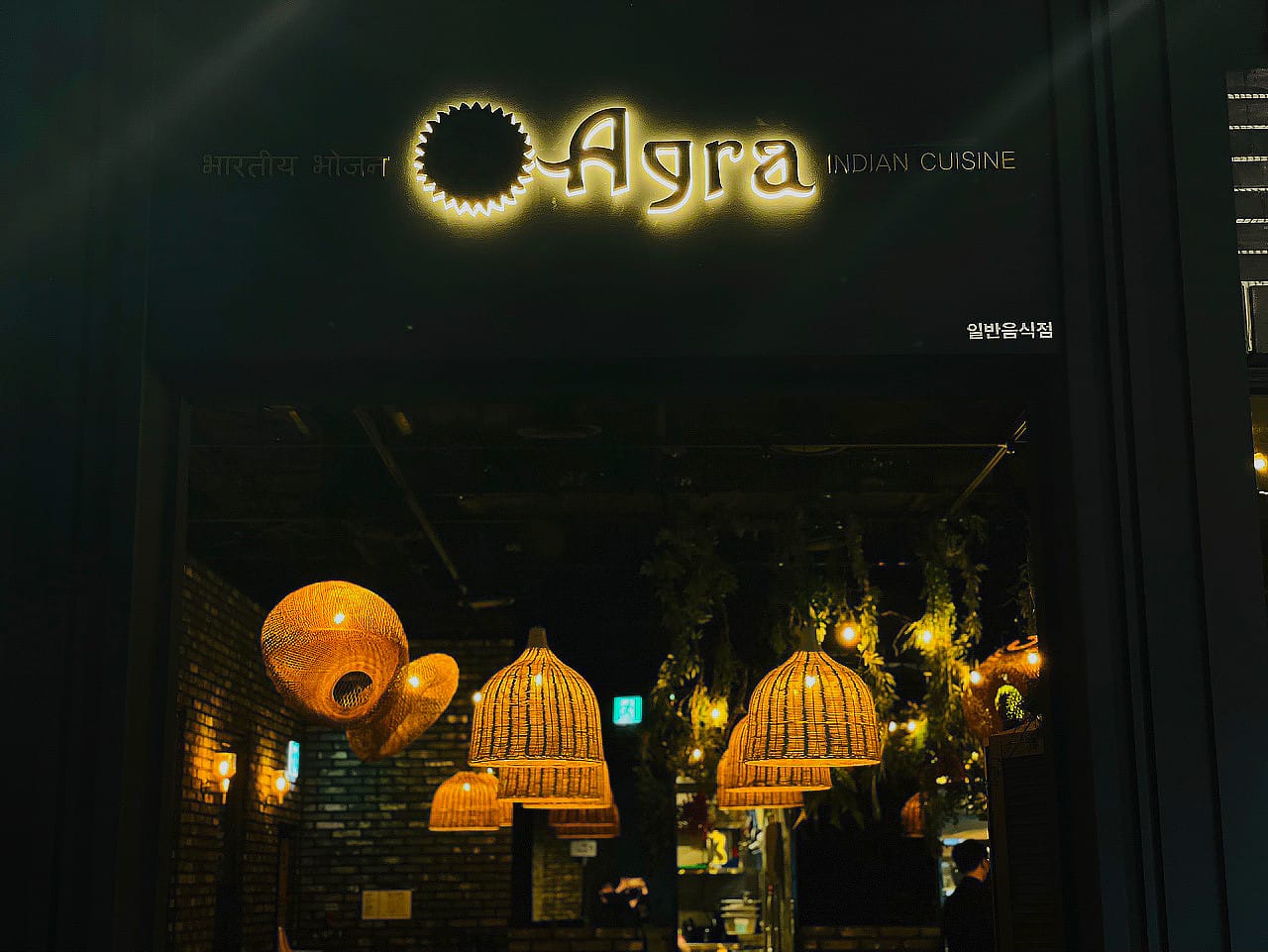 Exterior view of Agra Indian Cuisine at Shinsegae Department Store in Daegu, South Korea, featuring warm lighting and stylish décor