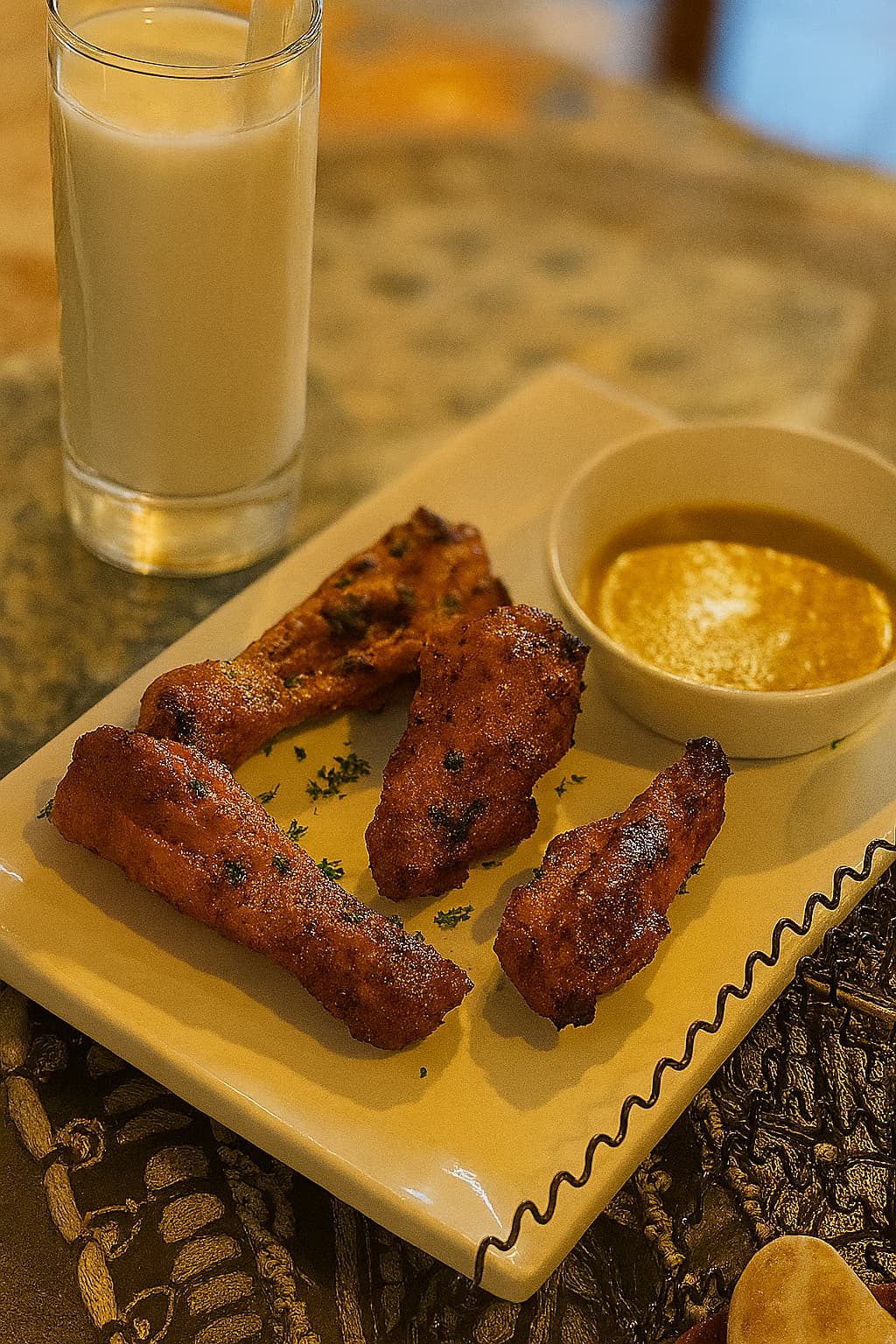 Tandoori chicken with dipping sauce and lassi served on a traditional table at Indian Curry House restaurant in Daegu