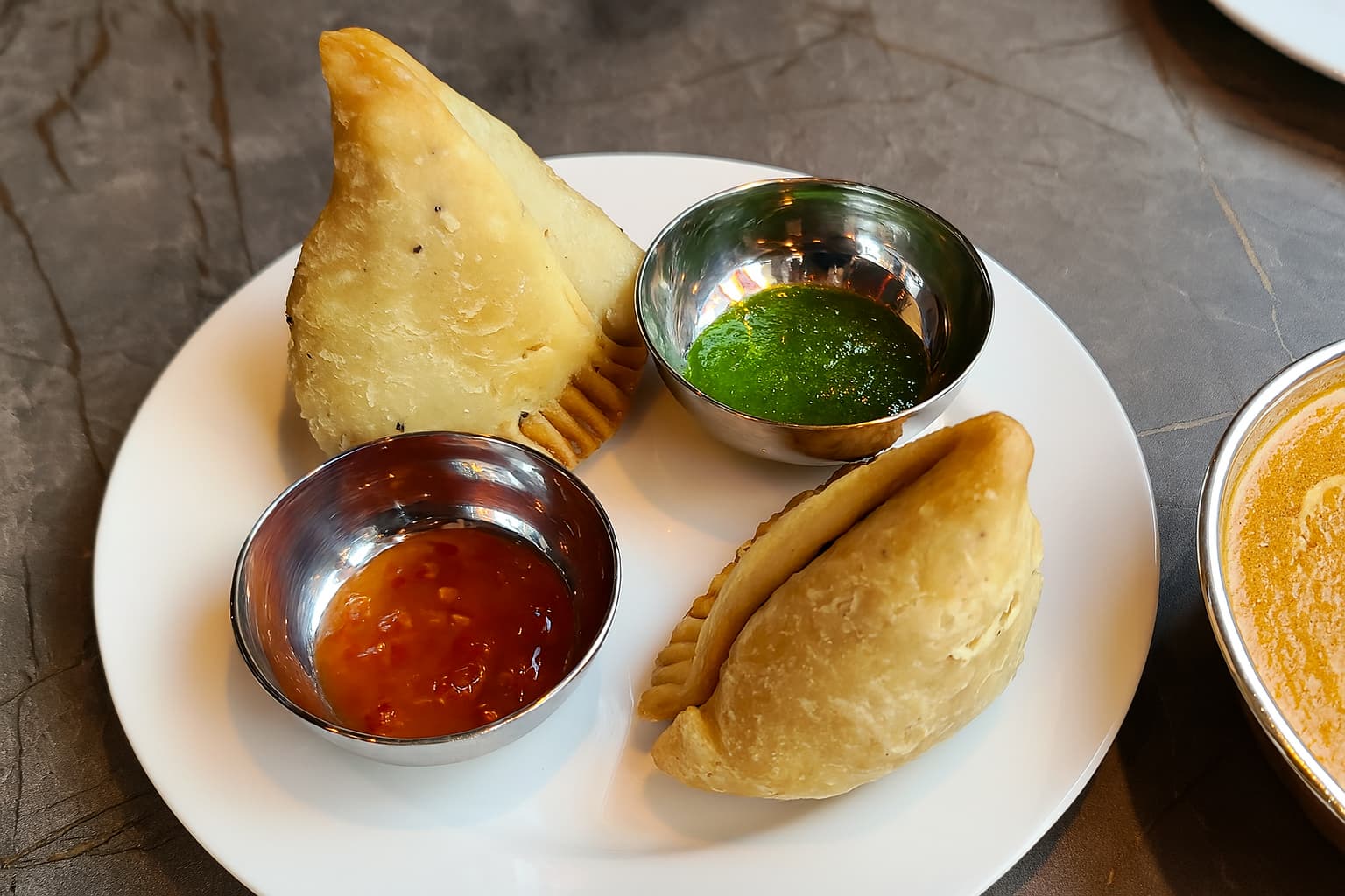 Samosa platter with green and red chutneys at Nepal Sarang Indian Restaurant in Gyeongsan near Daeg