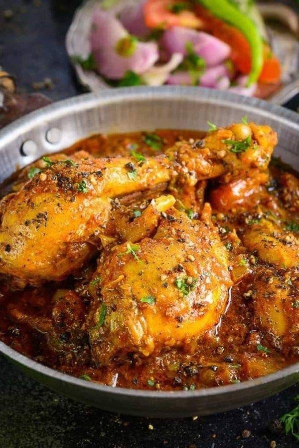 Spicy chicken curry topped with black pepper and herbs at New Saladin Seongseo Indian restaurant in Daegu