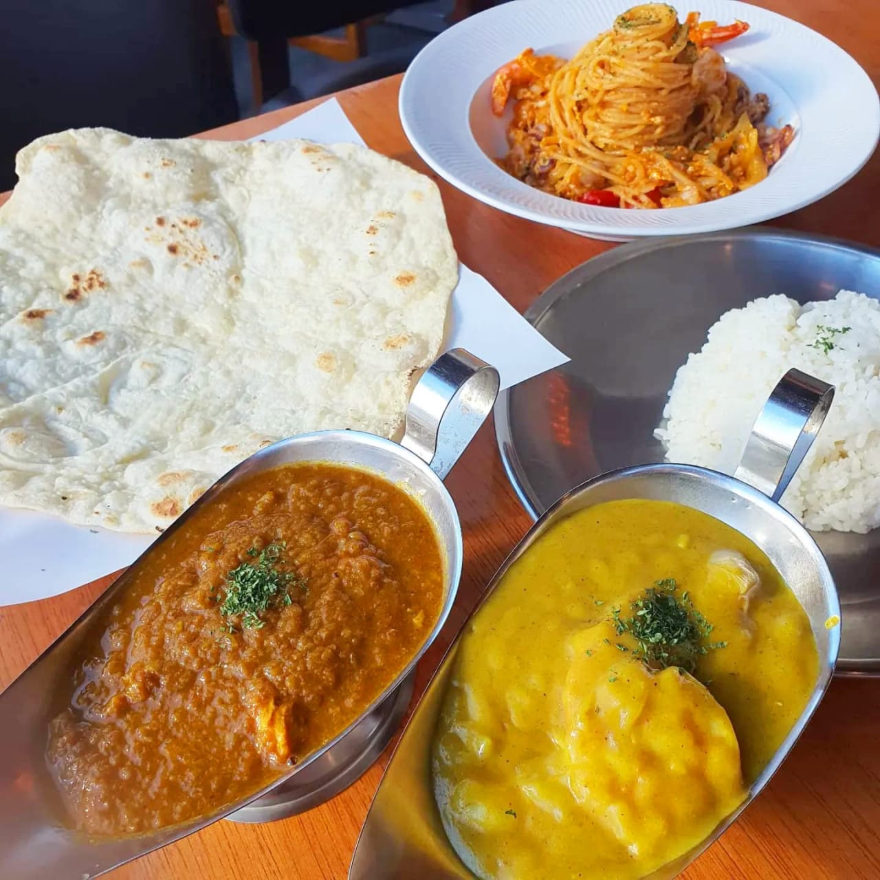Butter chicken and yellow curry with naan, rice, and pasta at Rama & Bavana Indian Restaurant in Suseong-gu, Daegu