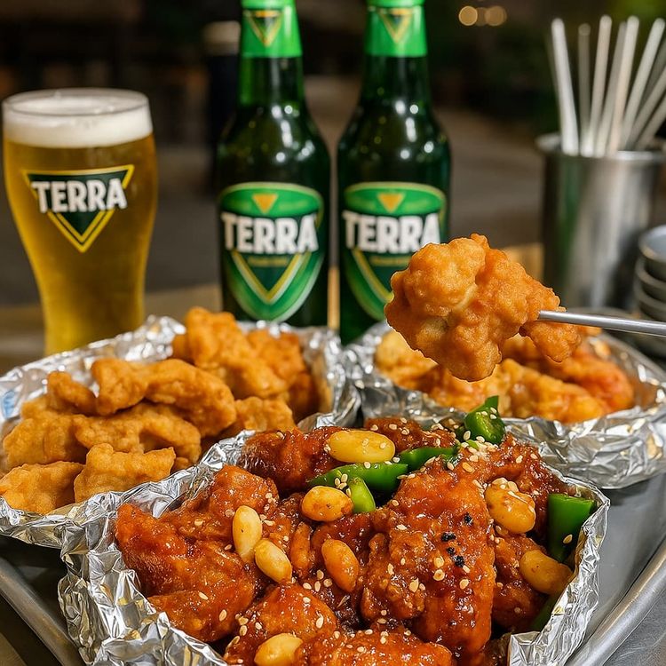 Korean fried chicken at Samdeok Tongdak in Daegu with spicy garlic sauce, crispy classic pieces, and Terra beer