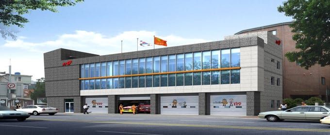 Street view of Samdeok 119 Safety Center in Daegu, South Korea, showing a modern two-story fire station with emergency vehicles and national flags