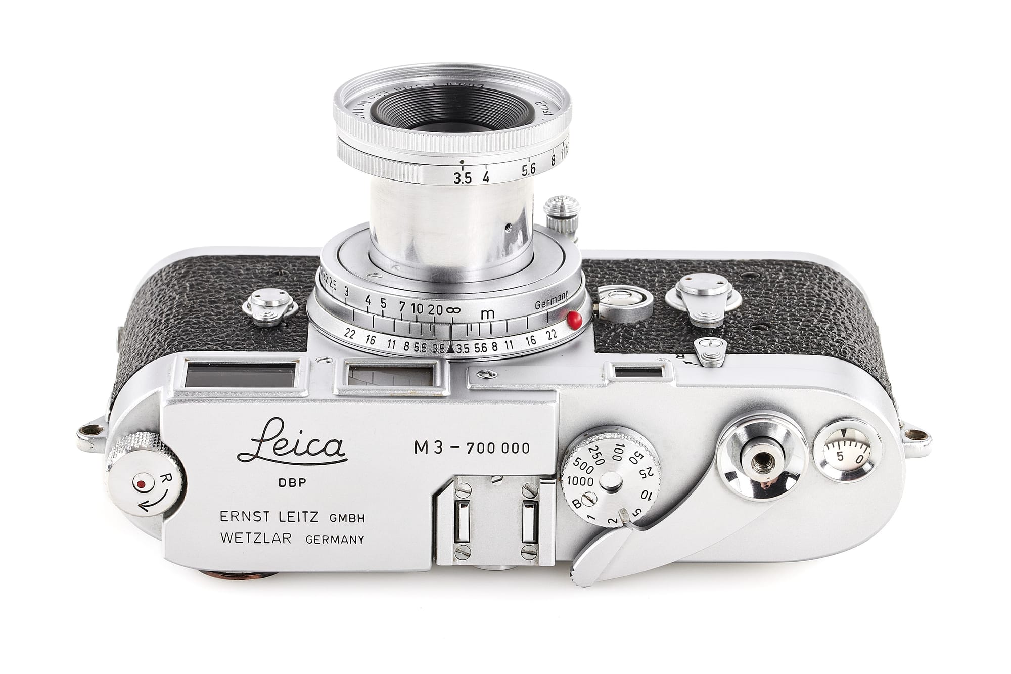 Image of a vintage Leica M3 camera laying on its back with the top showing