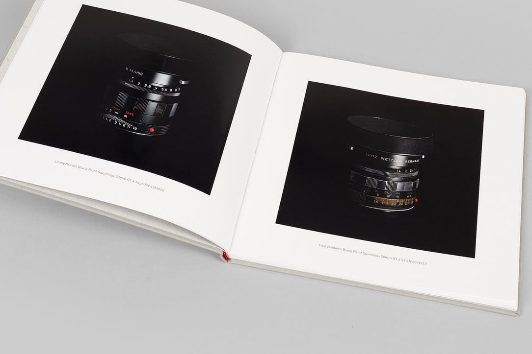 overhead view of a book showing two images of vintage Leica lenses