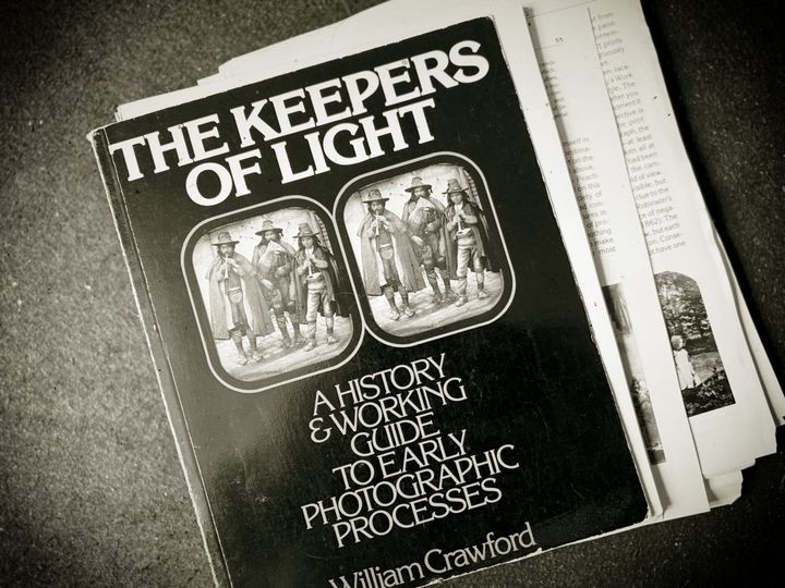 overhead view of a book with some of its pages loose around it.