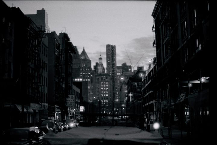 city view at dusk with lights on in buildings