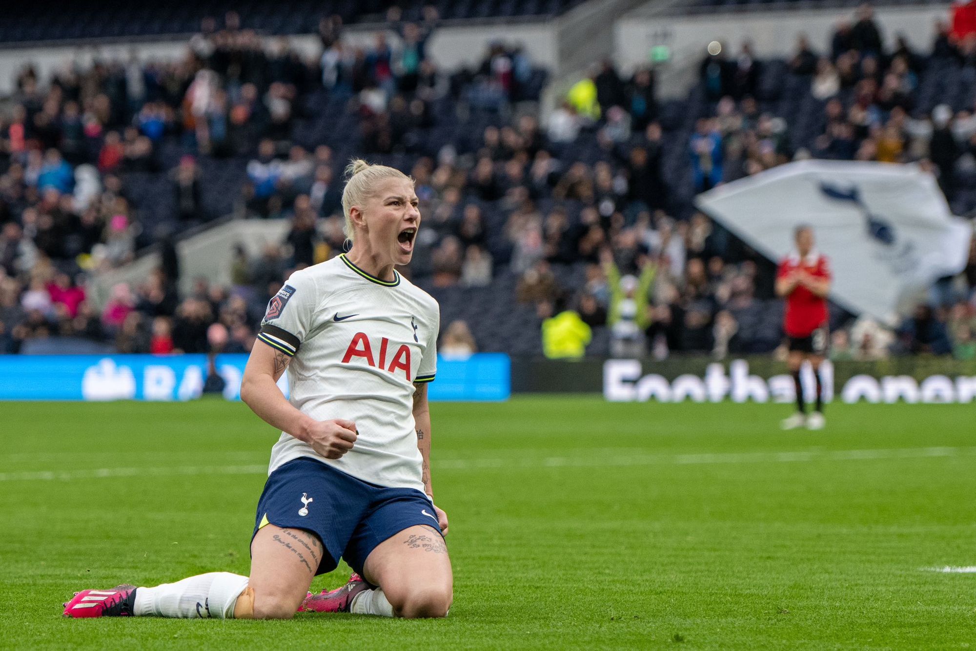 Beth England celebrates her goal against Manchester United with a knee slide.
