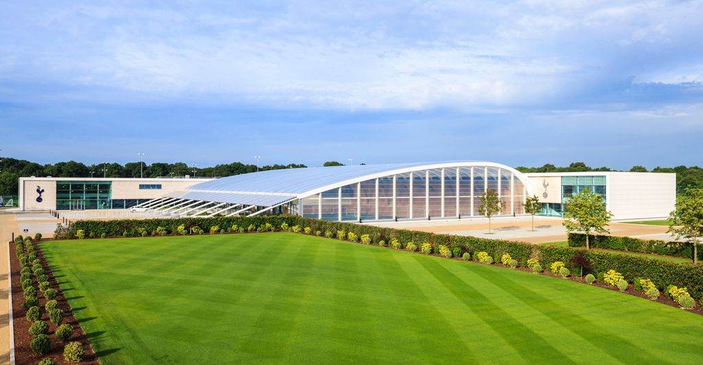 One of the training pitches at Hotspur Way, with the indoor training facility buildings in the background.