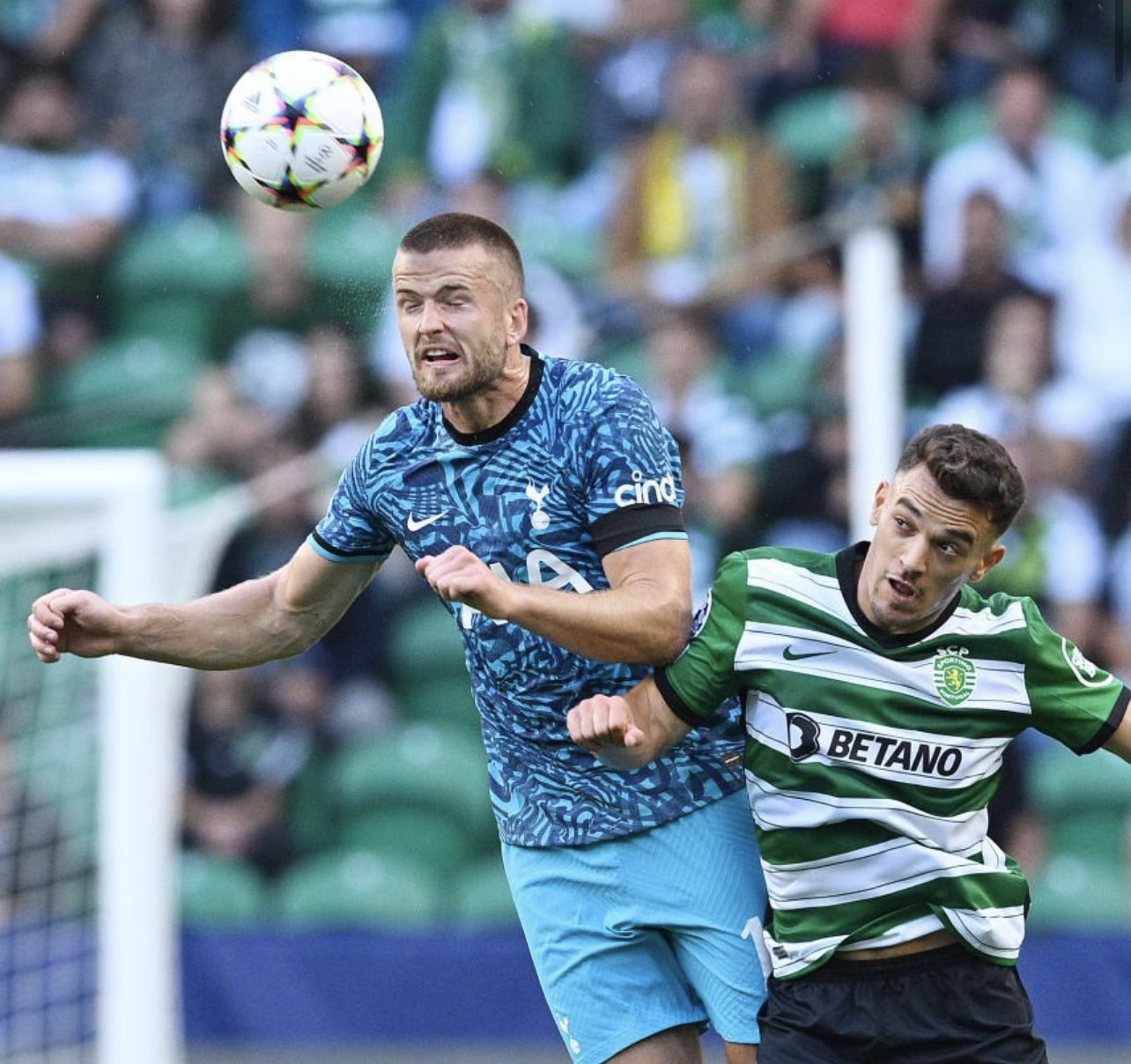Eric Dier winces after heading the ball away from a Sporting player.