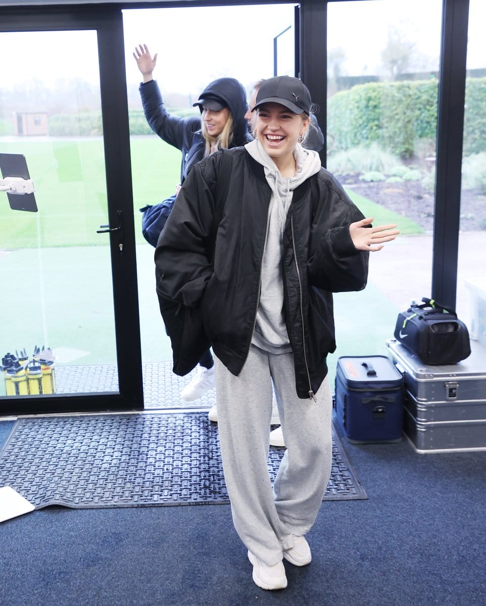 Charli Grant waves in welcome as she arrives at the training ground.