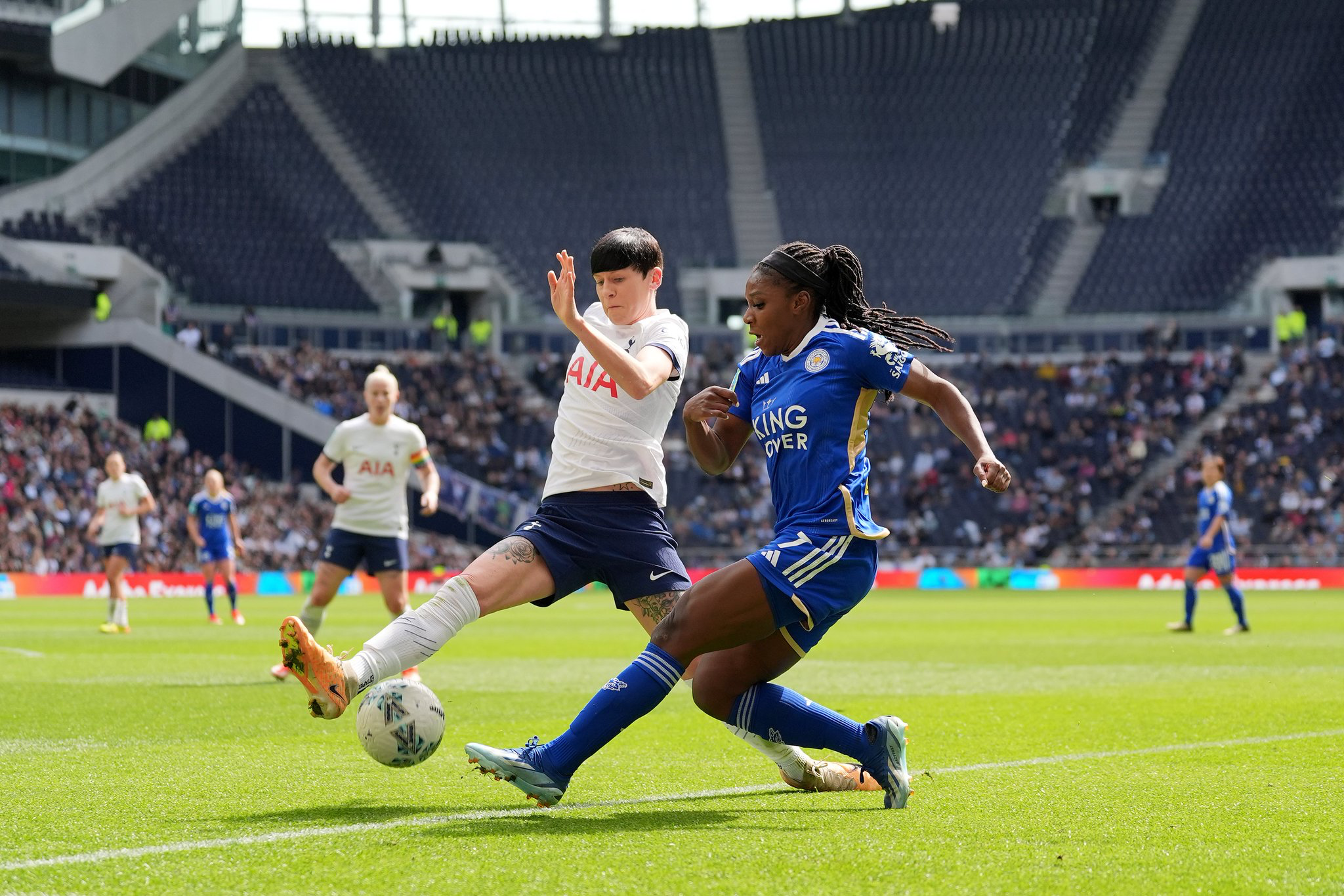 Ash Neville blocks a cross from Deanne Rose.