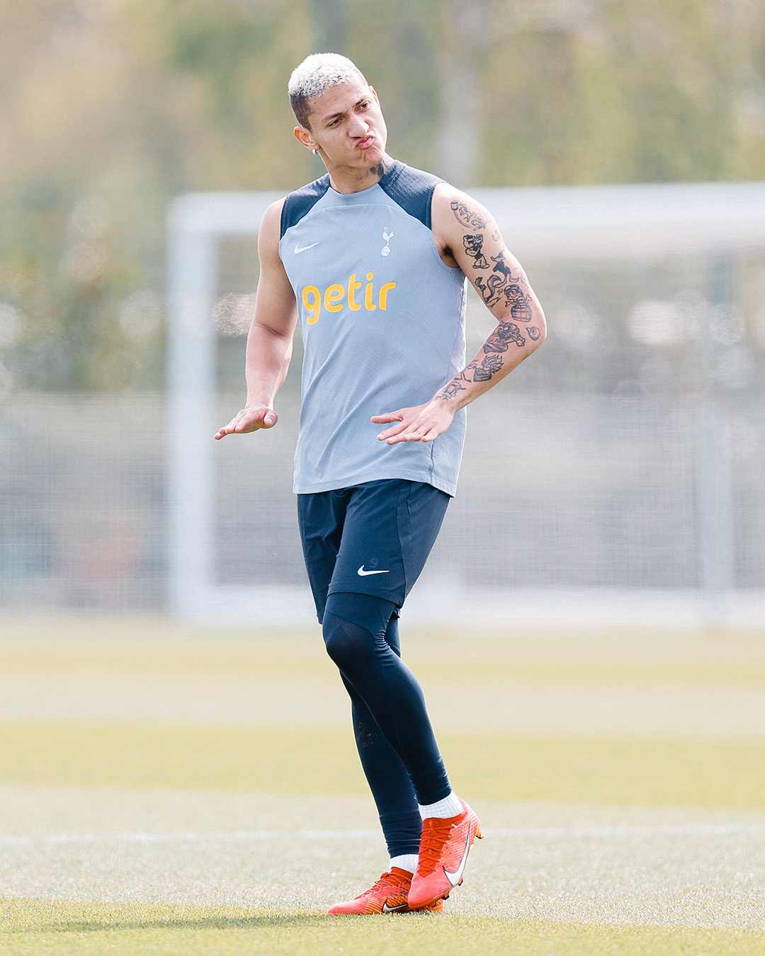 Richarlison mimes "calm down" during a recent training session.